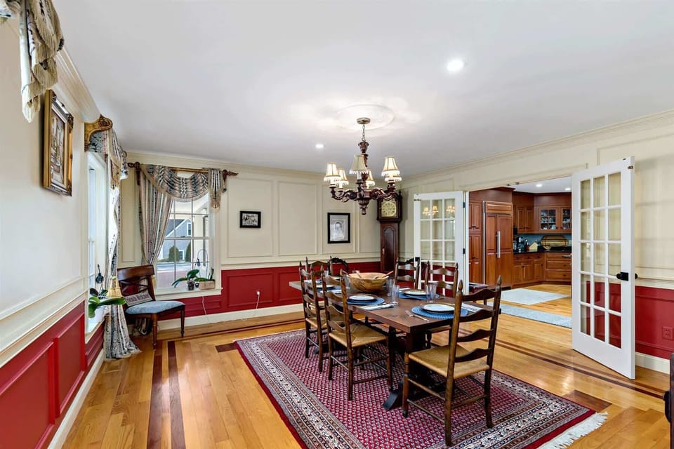 Dining room connects to the chefs kitchen, easy serving, family-style meals, and gathering space for Cape Cod vacations.