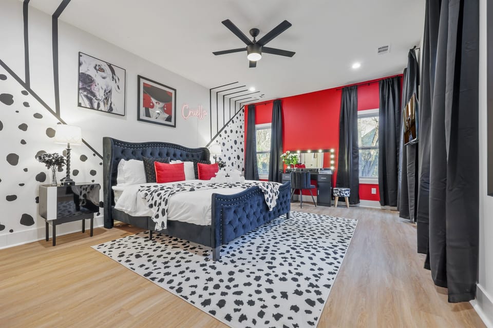 Cruella-Inspired Master Bedroom: Immerse yourself in bold elegance with black-and-white Dalmatian decor, pops of red, and glamorous touches that redefine luxury. #CruellaTheme #DisneyInspiredStay #LuxuryVacationRental #BoldDecor #ThemedStayATL
