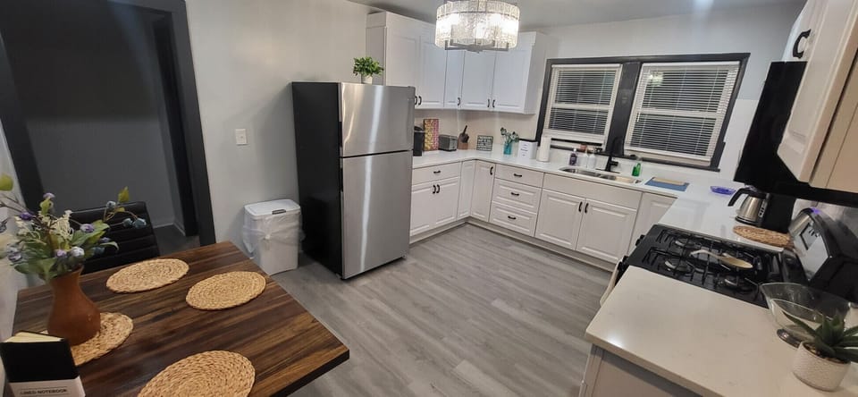 Our fully equipped, modern kitchen offers a spacious and functional layout with ample counter space and all the essential cookware needed to easily prepare home-cooked meals during your extended stay.