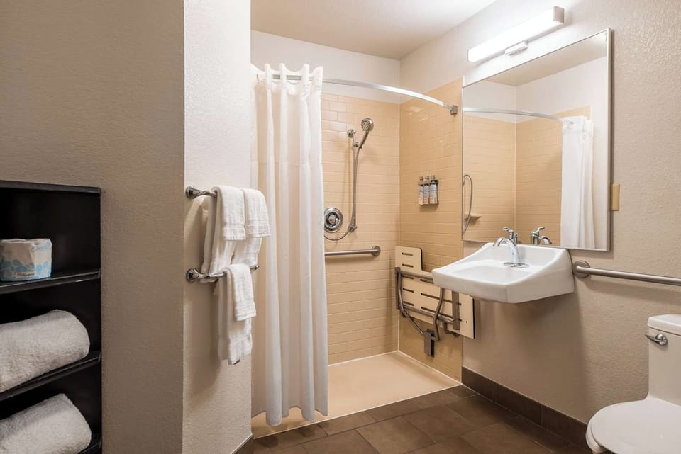 Start your day easily with towels, vanity, and walk-in shower.