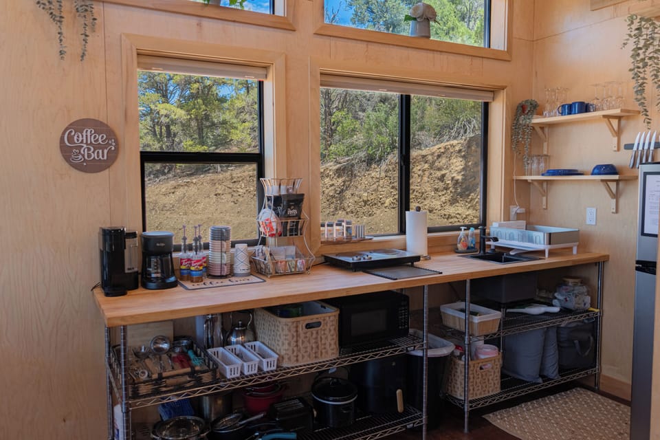 Sunny coffee bar and kitchenette with forest views and natural light