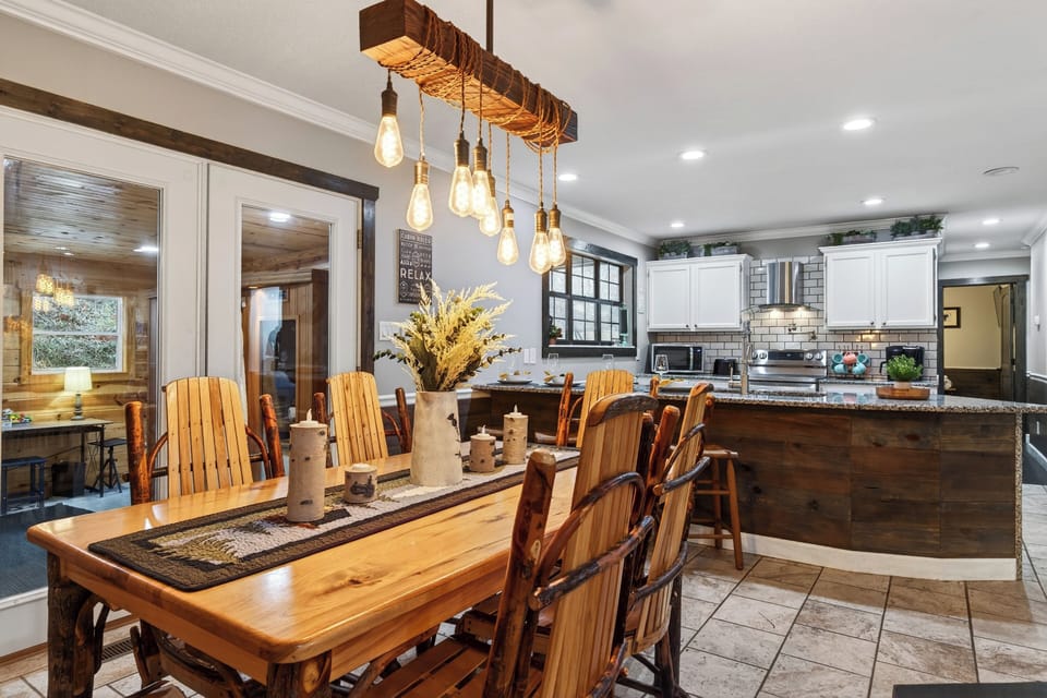 Share memorable meals at the handcrafted dining table, set beneath warm pendant lighting and framed by mountain-inspired artwork.