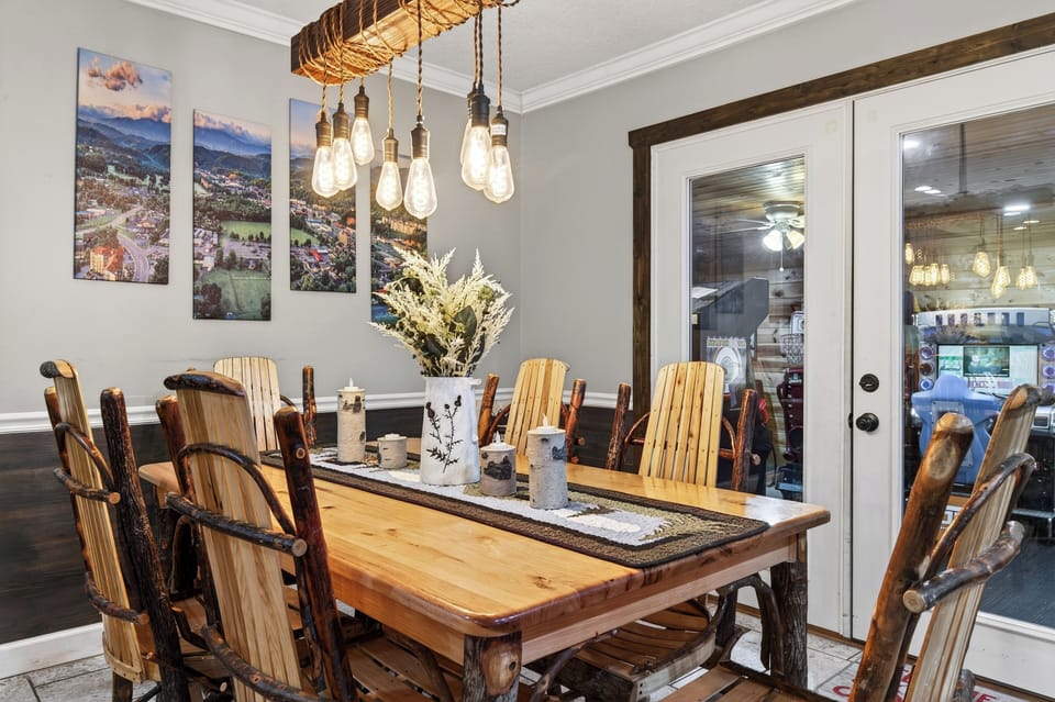 Share memorable meals at the handcrafted dining table, set beneath warm pendant lighting and framed by mountain-inspired artwork.