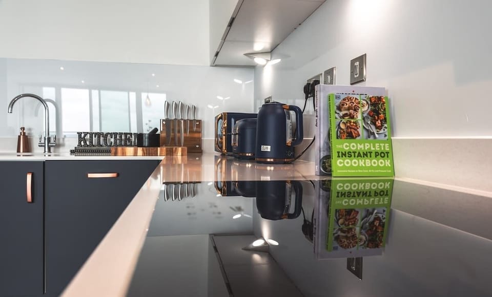 Sleek and modern kitchen, outfitted with top-tier utensils and appliances,