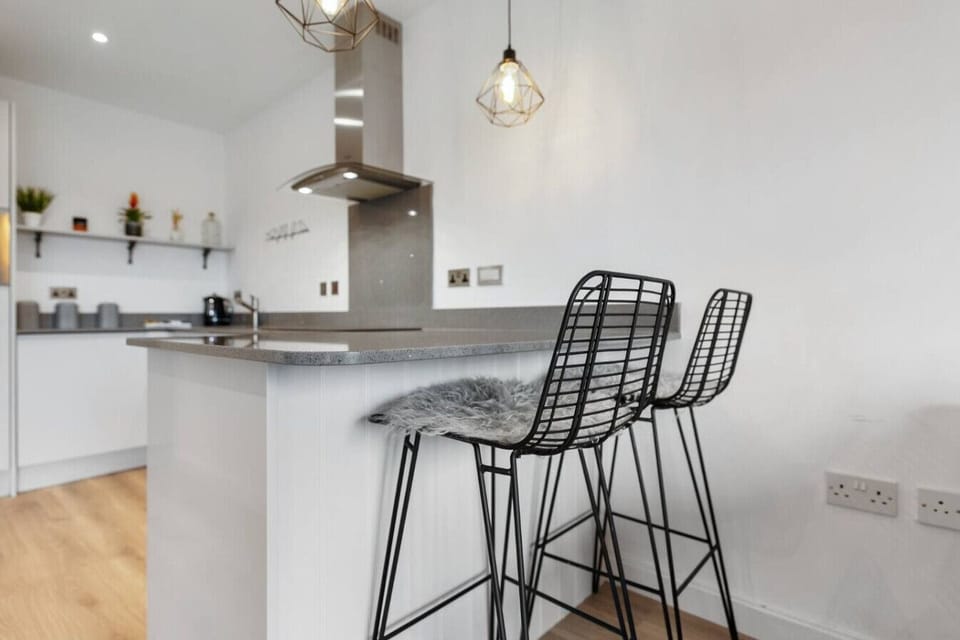 Start the morning at the breakfast bar with high stools and a bright kitchen setup.