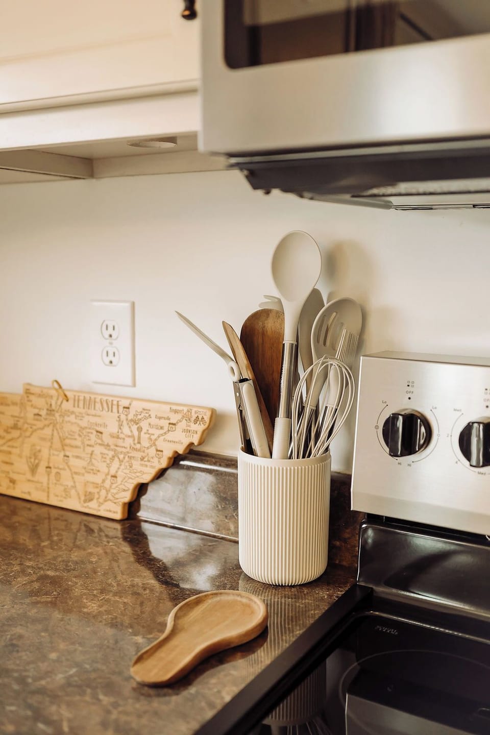 Modern kitchen with full cookware and dining essentials so you don't have to worry about packing a thing! Included: Stove, oven, refridgerator, cooking utensils, baking pans, muffin pan, pizza pan