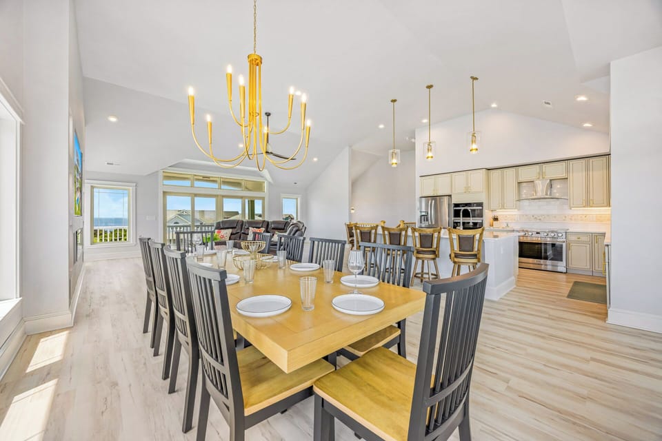 Gather around this spacious dining table where your group can share meals together, with the open kitchen and living areas creating an inviting flow for effortless entertaining and connection.