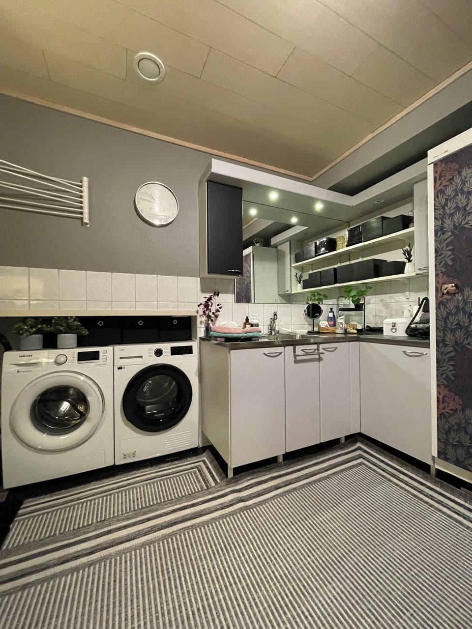 Housekeeping room, washer and dryer and sink.