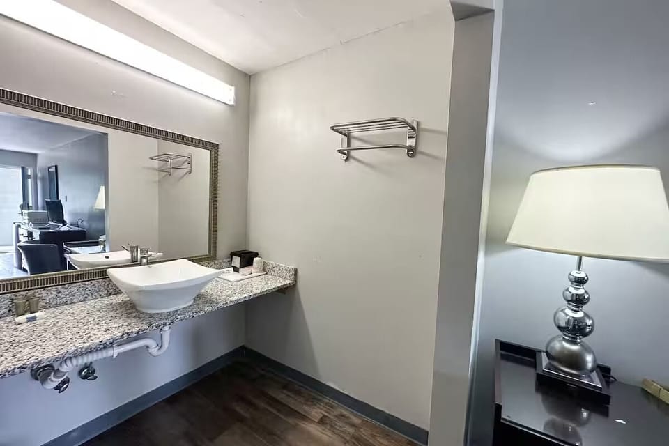 Refresh at the roomy granite vanity with bright mirror lighting.