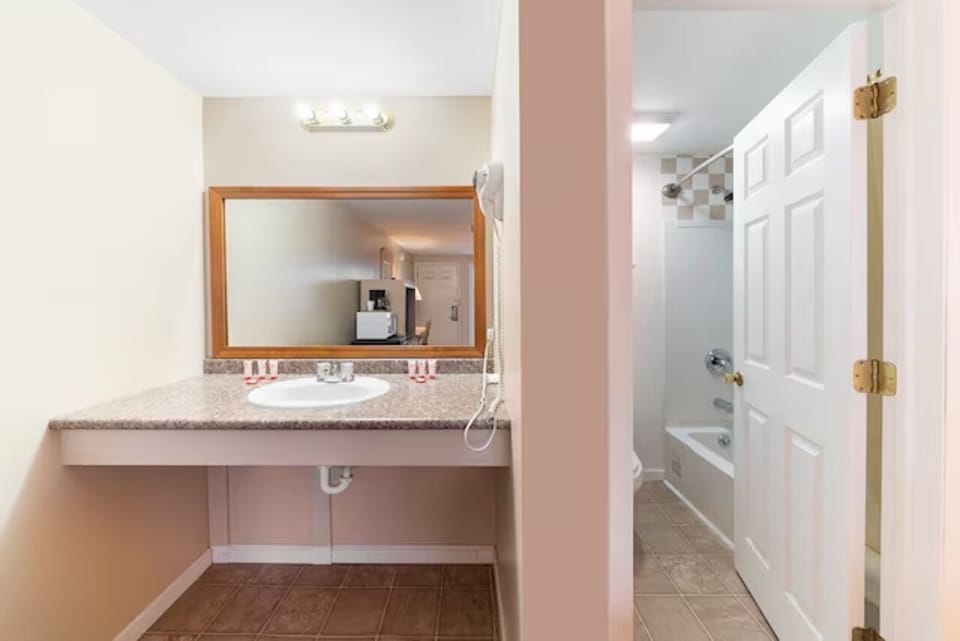 Refresh at a roomy vanity with bright lighting and space.