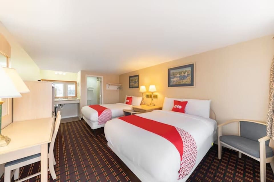 Relax in a spacious room with comfortable beds and warm lighting.