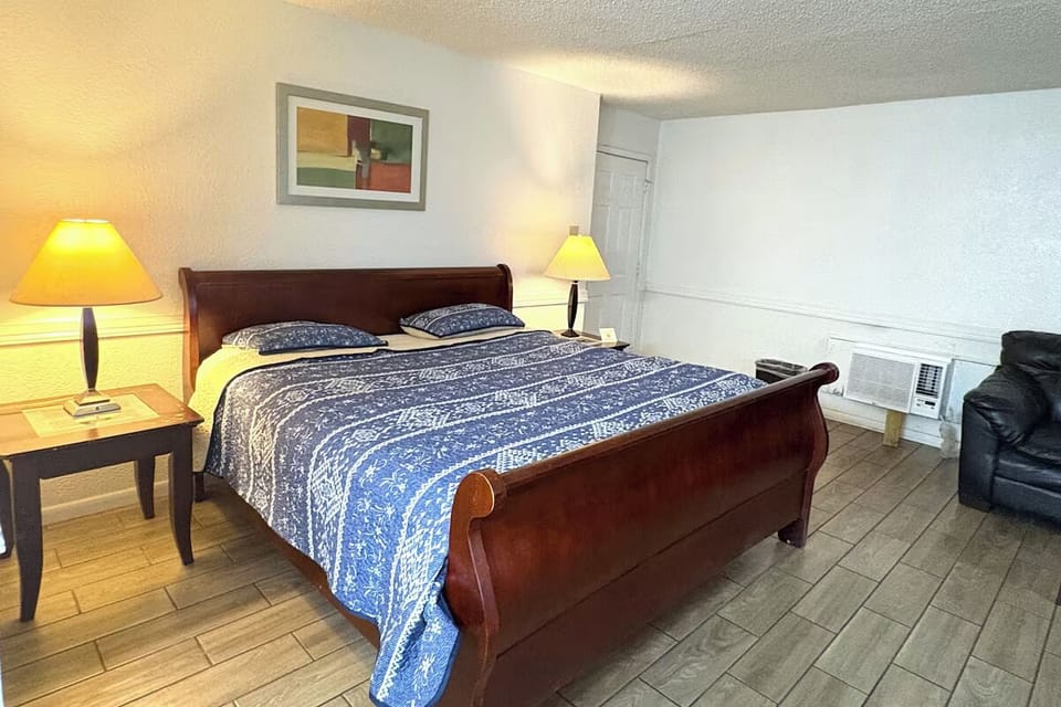 Drift off peacefully in a comfortable bed with soft lamplight.
