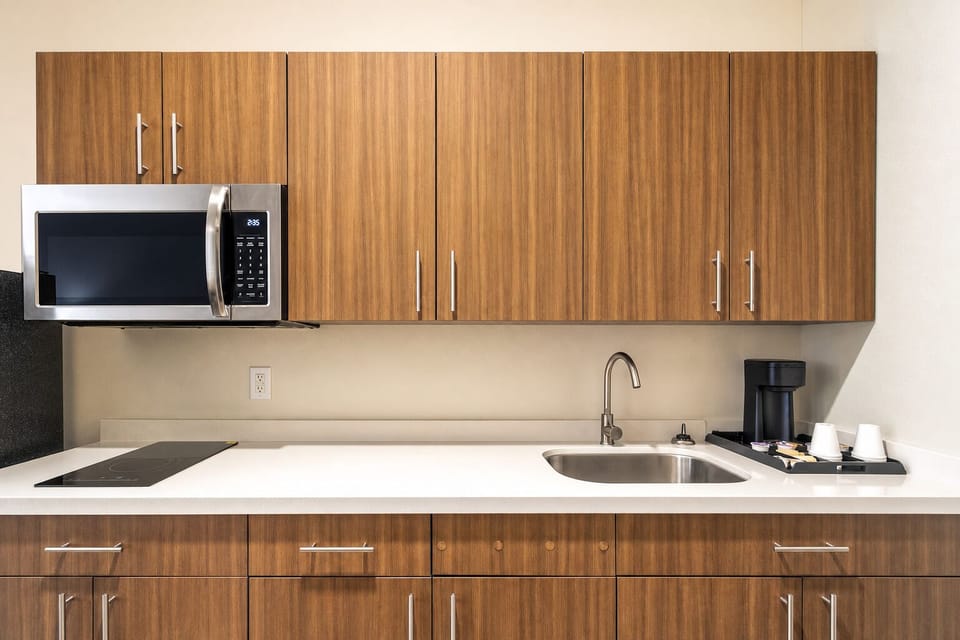 Cook and recharge easily with sleek kitchenette, microwave, and sink.
