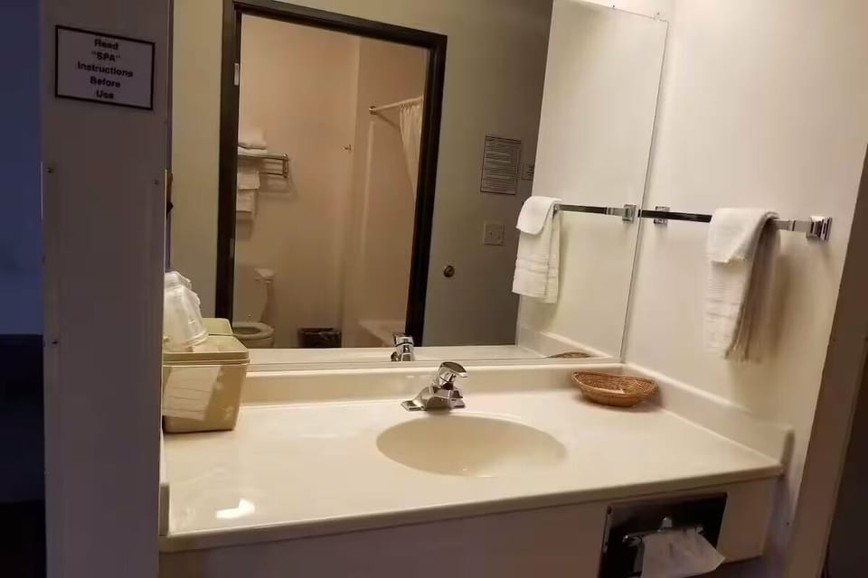 Refresh at the bright vanity with plush towels within reach.