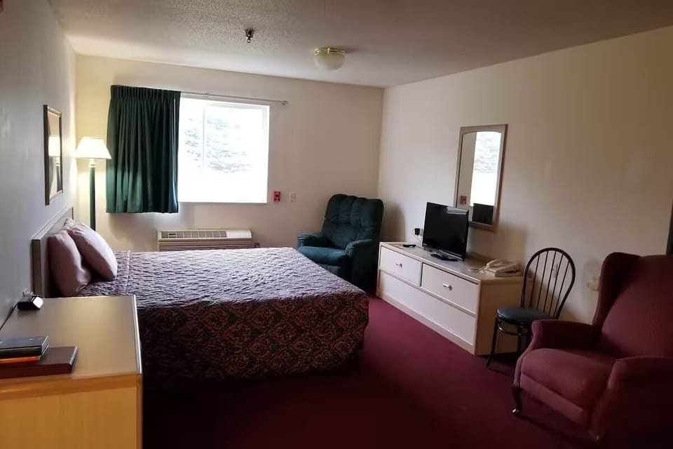 Recharge in a calm king room with lounge seating and TV.