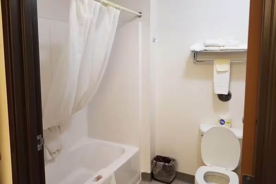 Refresh with a simple tub-and-shower setup and clean towels.