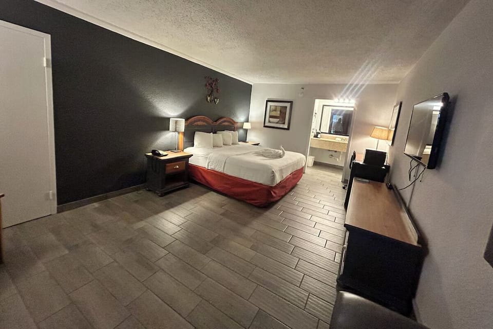 Unwind in a spacious room with cozy king bed.