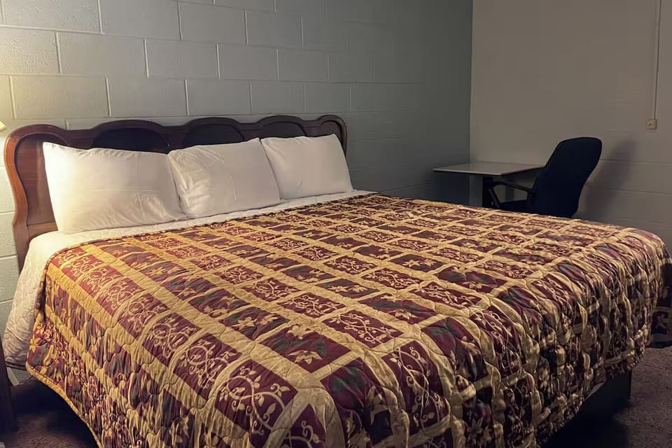 Lounge comfortably in a roomy king bed with simple workspace.