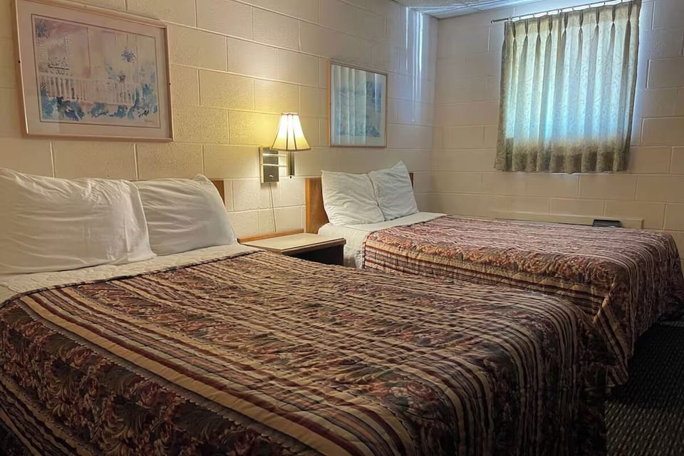 Relax into two inviting beds with warm, restful ambiance.