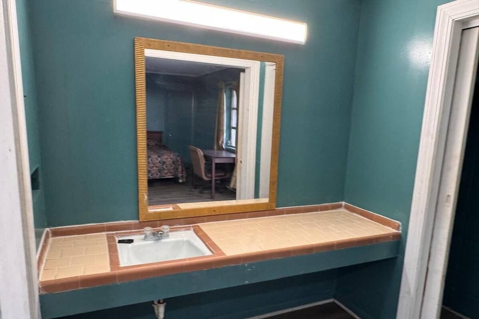 Get ready with a wide vanity counter and bright mirror lighting.
