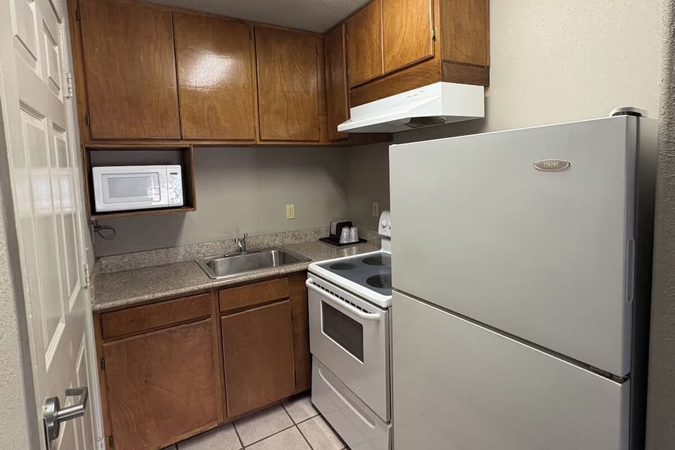 Cook quick meals easily with full fridge, stove, and microwave.