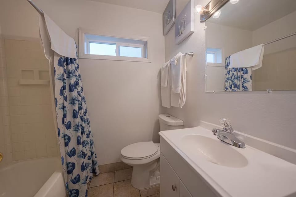 Refresh effortlessly in a bright bathroom with clean tub shower.