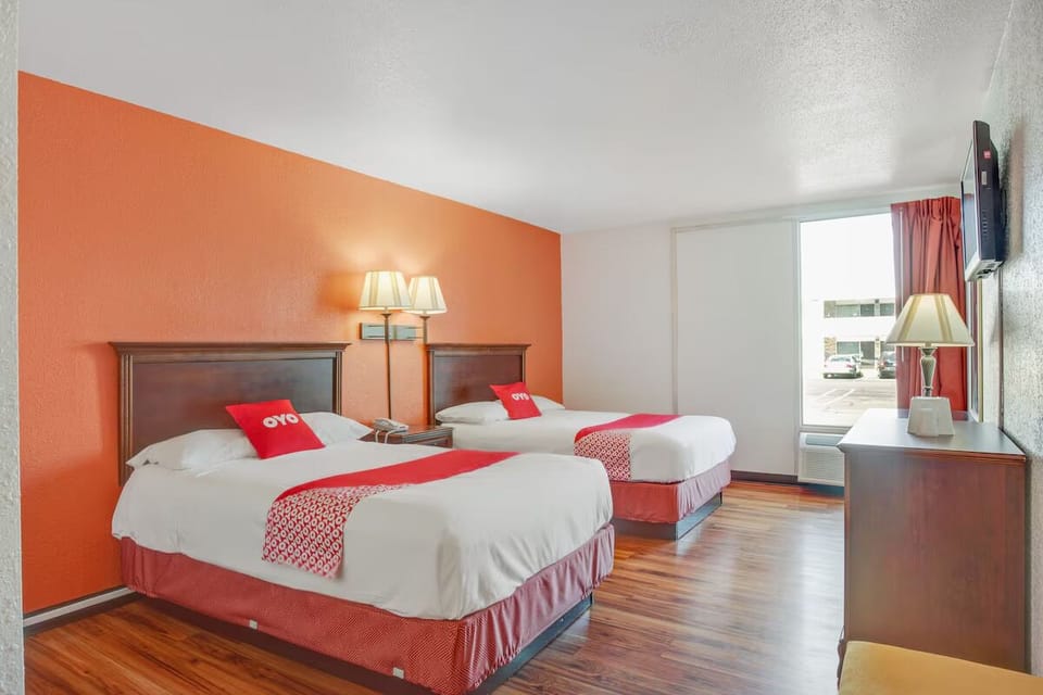 Settle in with two beds, TV, and sunny window views.