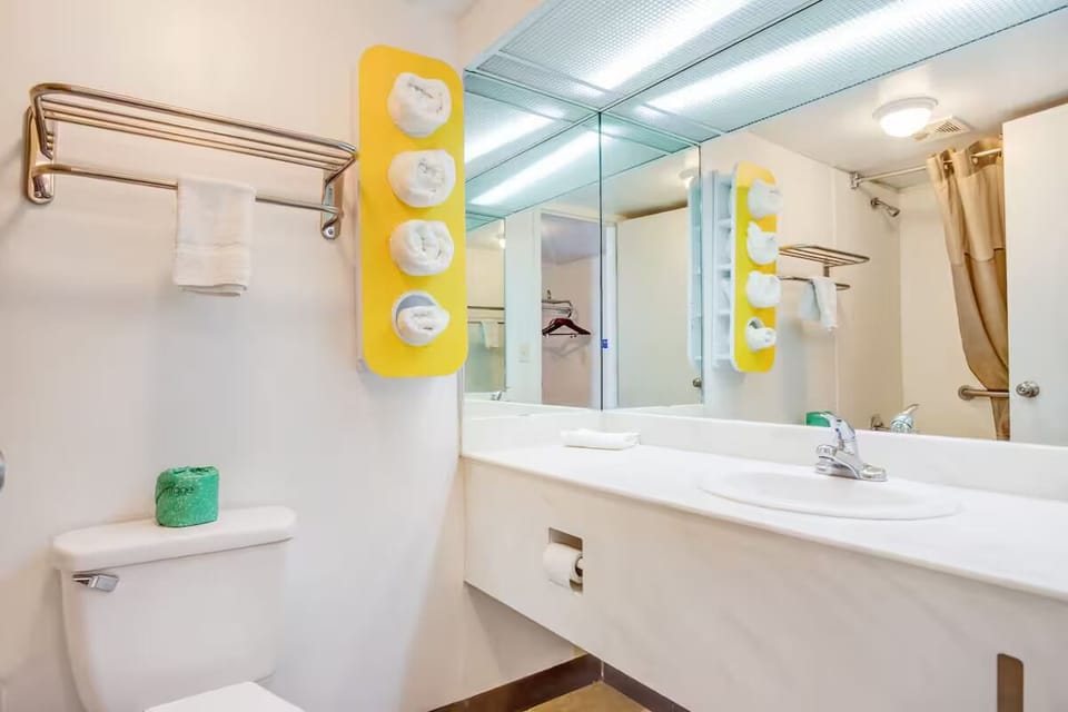 Refresh at the bright vanity with fluffy towels ready.
