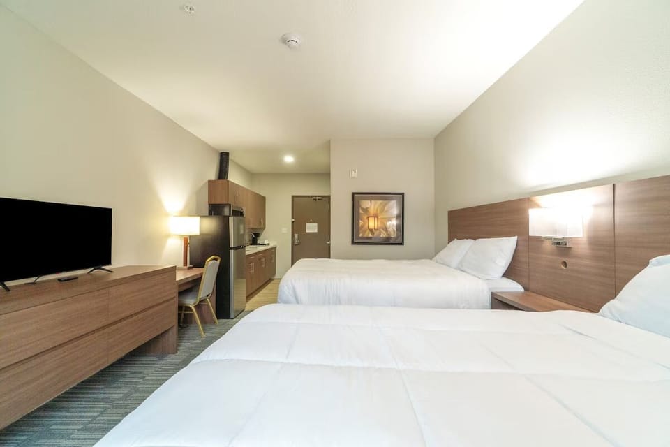 Unwind in bright double-queen comfort with convenient in-room kitchenette.
