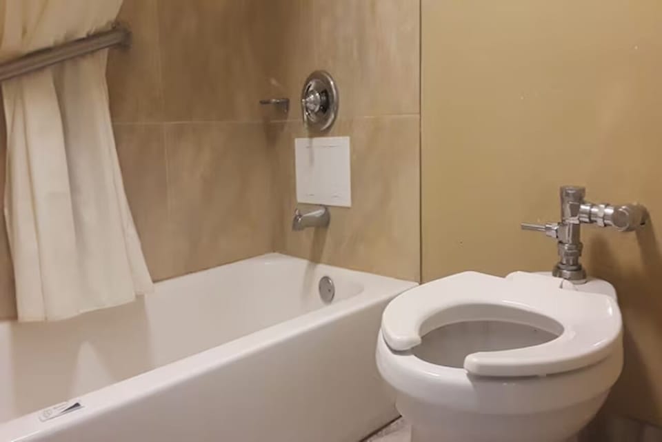 Rinse off in a clean tub-and-shower setup after adventures.