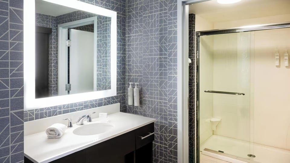 Refresh under a bright, glass shower in modern style.