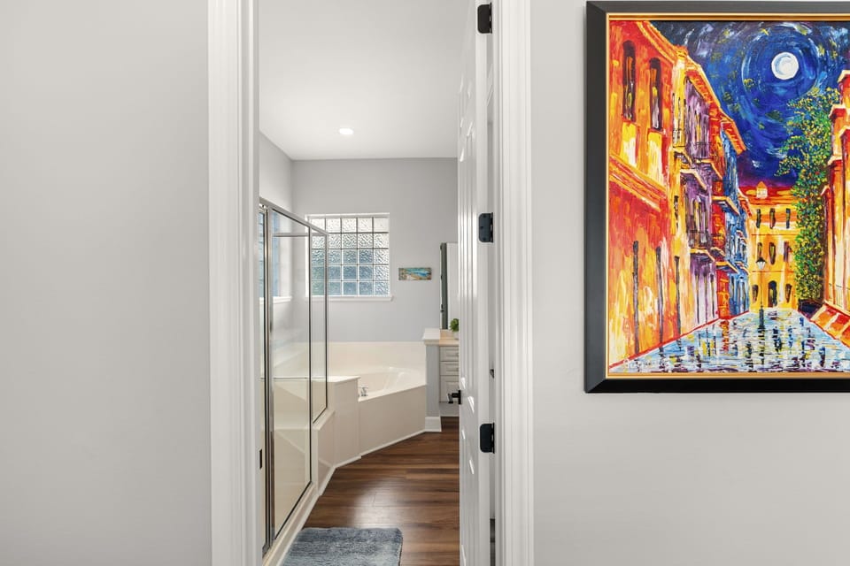 Step into the spa-like En-Suite featuring a soaking tub and Walk In shower, perfect for unwinding after exploring.