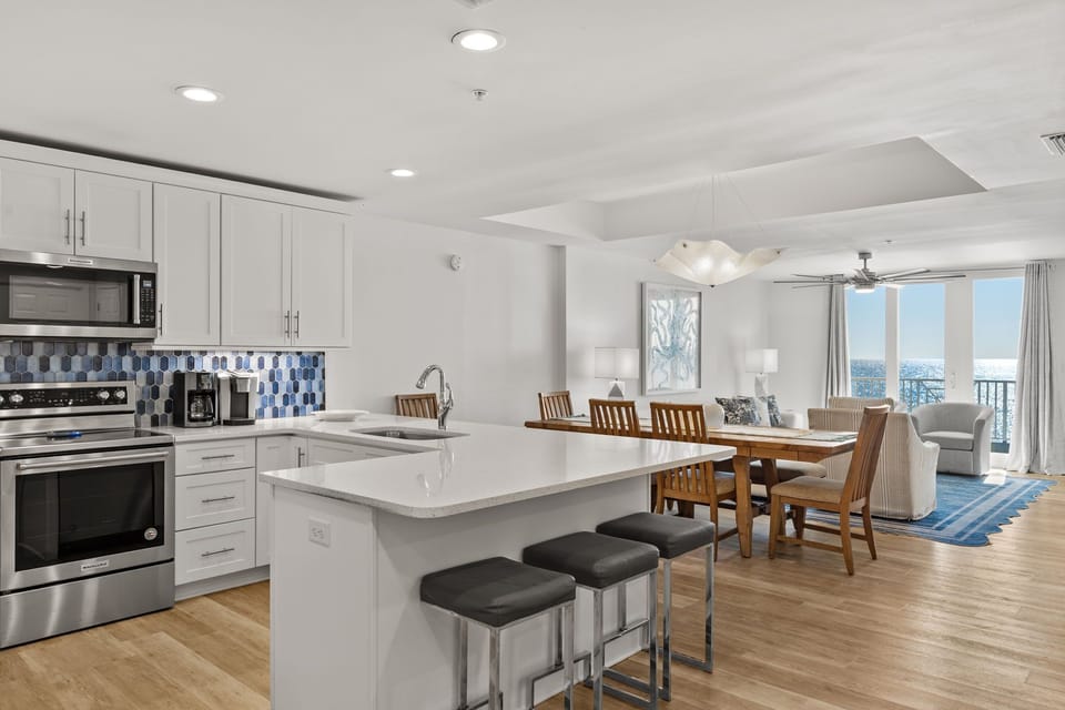 The open-concept kitchen flows into the dining and living areas.