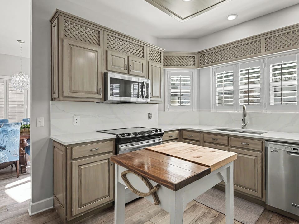 Your beautiful kitchen features elegant cabinetry, marble countertops, and modern appliances, perfect for preparing meals during your stay.