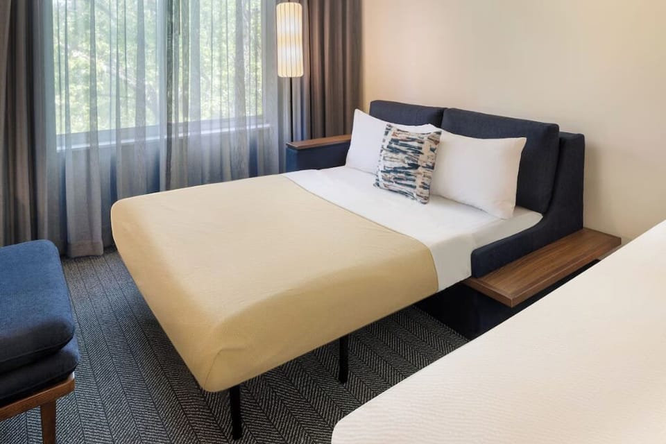 Unwind into plush pillows beside calming daylight and soft linens.