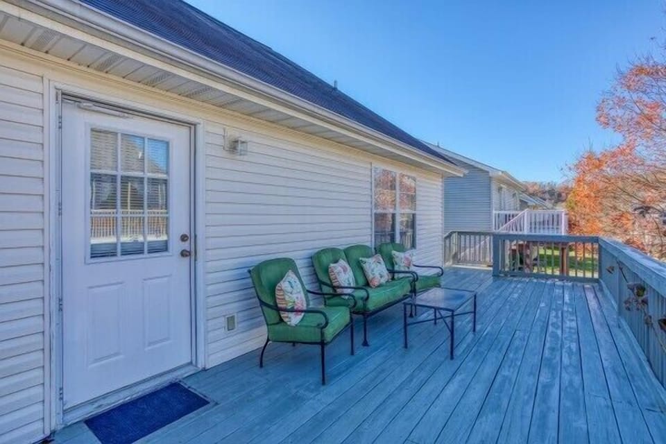 Back deck with seating at Peace at the River, a 3 bedroom cabin rental located in Pigeon Forge