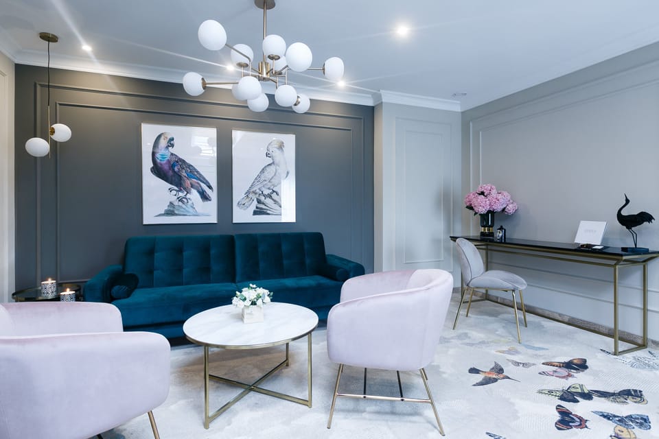 Gather for cocktails in a chic lounge with elegant workspace.