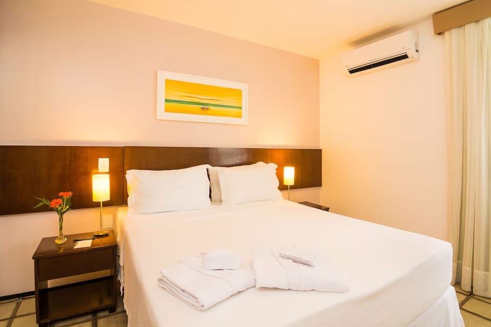 Sink into a plush king bed under warm, cozy lighting.