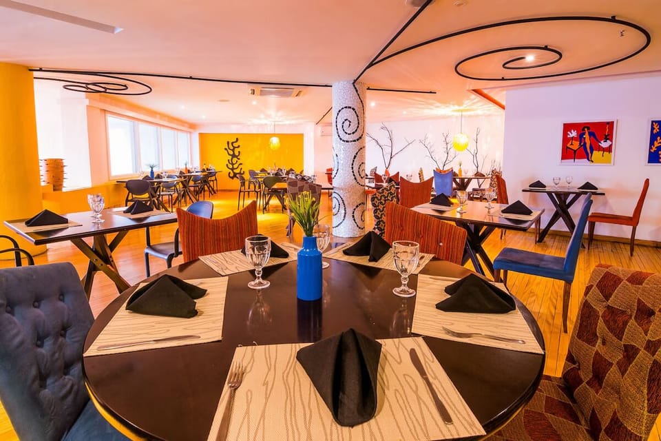 Savor relaxed dinners in a vibrant, art-filled dining room.