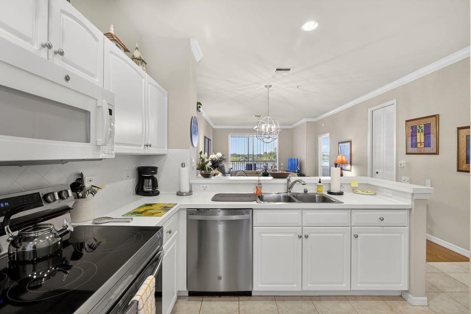 Fully-equipped kitchen features modern appliances and opens to the living space.