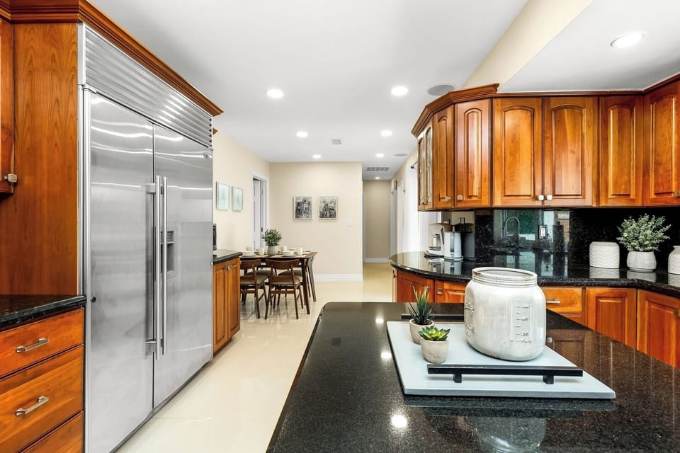 We kept the kitchen solid. Solid wood that is! But we did add top of the line appliances and sleek granite countertops for a modern feel. 
