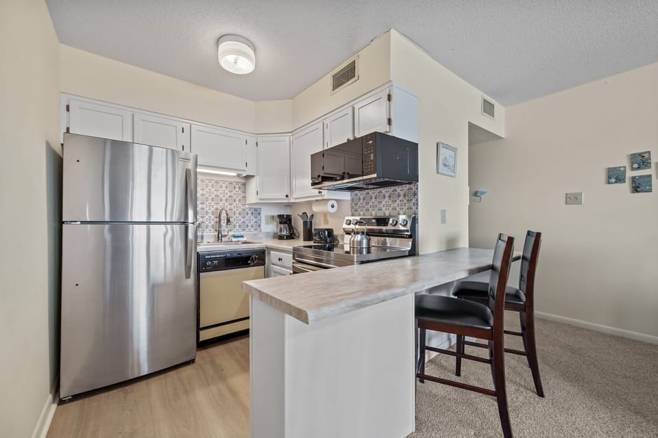 Updated kitchen with stainless steel appliances and a spacious counter, ideal for cooking, coffee, or quick breakfasts