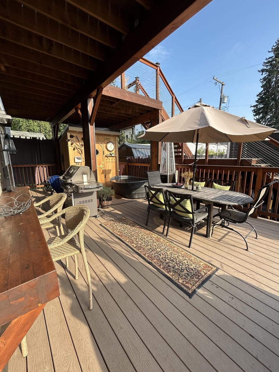 Spacious covered deck with cozy seating and dining area