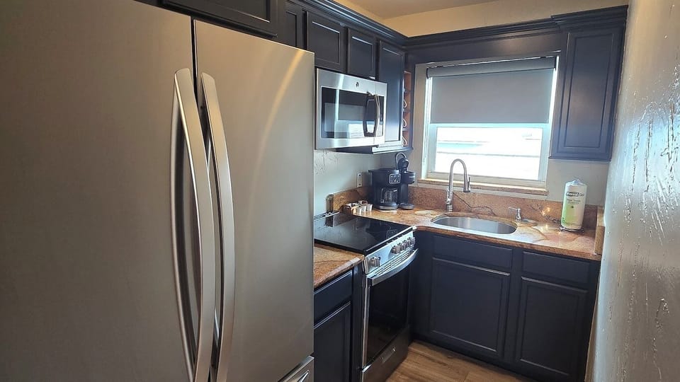 Cook with ease in a sleek kitchen with full appliances.