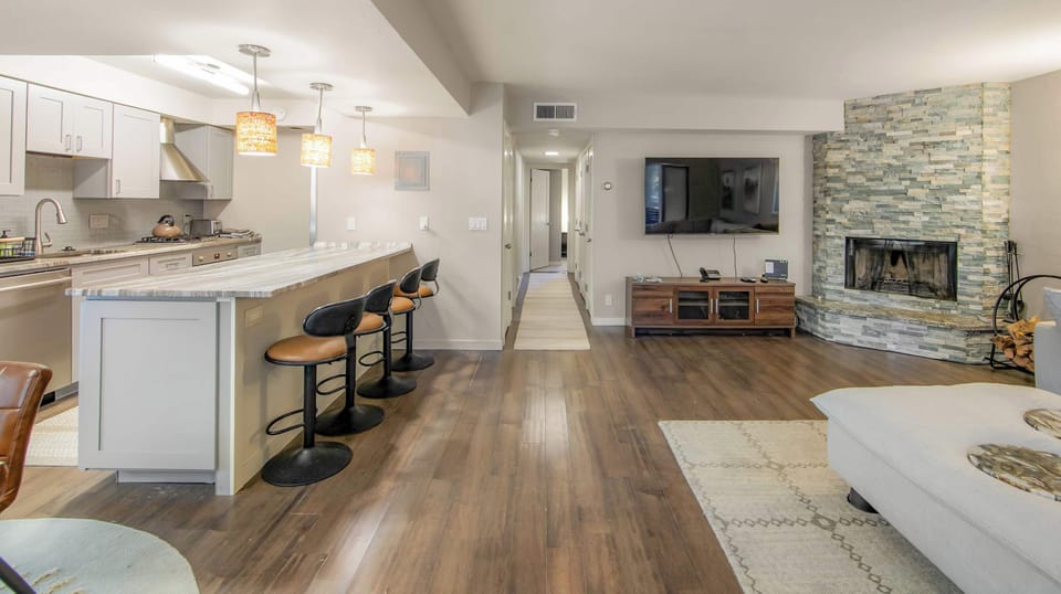 Spacious living room featuring a large couch and smart TV