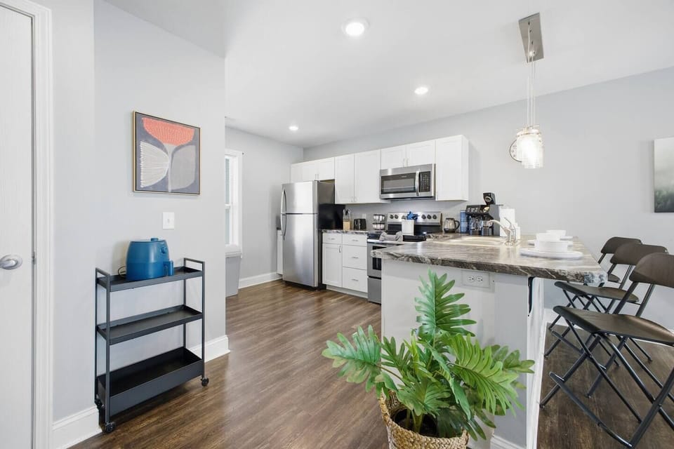 Bright modern kitchen with stainless suite and breakfast bar seating