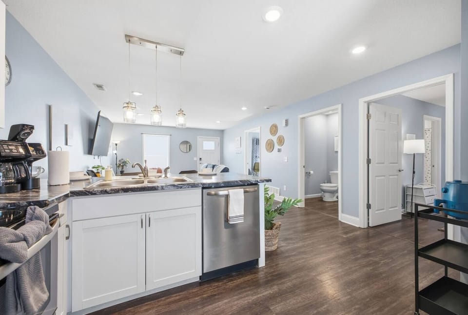 Bright open kitchen-living with stainless appliances and cozy style.