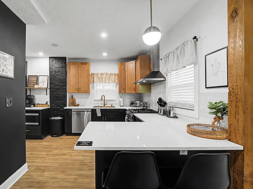 Bright kitchen island w/ seating & statement pendant lights