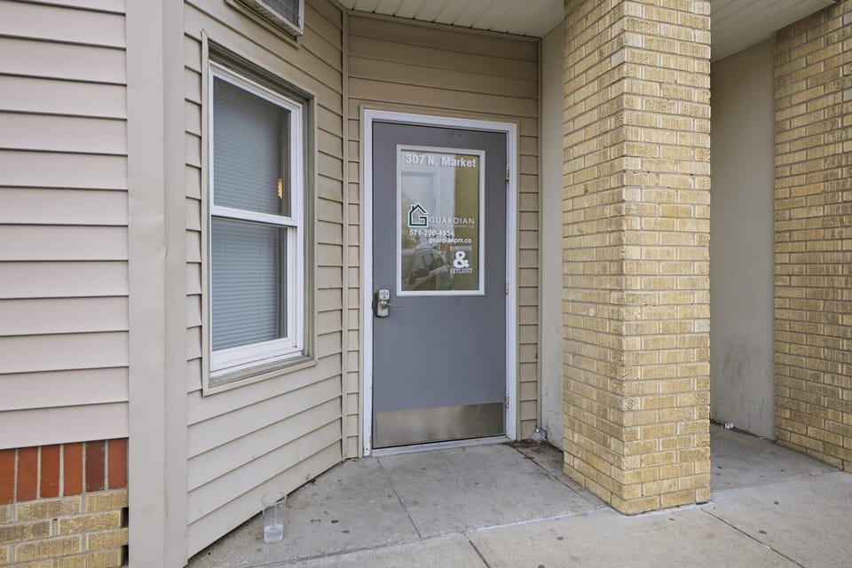 Secure, street-level entrance with covered alcove for easy access.