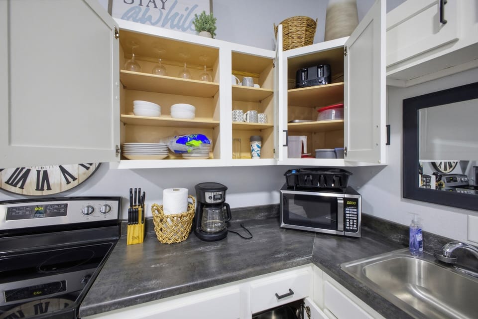 Fully stocked kitchenette with microwave, toaster, and coffee station
